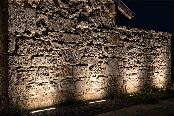 A stone facade illuminated with grazing light to show its texture